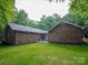 Expansive backyard featuring a brick patio, well-maintained lawn, and mature trees, perfect for outdoor activities at 300 Hugh Crocker Rd, Matthews, NC 28104