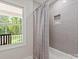 Bathroom showcasing a tiled shower, tub, and view of the outdoors at 300 Hugh Crocker Rd, Matthews, NC 28104
