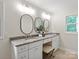 Bathroom with double vanity featuring granite countertop and framed mirrors above at 300 Hugh Crocker Rd, Matthews, NC 28104