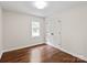 Empty bedroom with hard wood floors, a double closet and a window at 300 Hugh Crocker Rd, Matthews, NC 28104