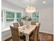 Bright dining room with a bay window, elegant lighting, and a beautifully set table for delightful gatherings at 300 Hugh Crocker Rd, Matthews, NC 28104