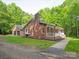 Charming home exterior featuring a brick facade, well-manicured lawn, and inviting front porch with a garage at 300 Hugh Crocker Rd, Matthews, NC 28104