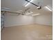 Spacious garage featuring neutral walls, sealed floor and overhead lighting at 300 Hugh Crocker Rd, Matthews, NC 28104