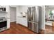 Bright kitchen featuring stainless steel appliances and white cabinetry, complemented by hardwood flooring at 300 Hugh Crocker Rd, Matthews, NC 28104