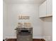 Functional laundry room with storage cabinet and decorative signs at 300 Hugh Crocker Rd, Matthews, NC 28104