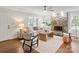 Inviting living room showcasing hardwood floors, a cozy stone fireplace, and a well-lit, comfortable layout at 300 Hugh Crocker Rd, Matthews, NC 28104