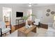 Stylishly arranged living room with hardwood floors and views into the kitchen and dining areas at 300 Hugh Crocker Rd, Matthews, NC 28104