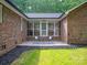 Cozy screened-in patio with brick flooring, comfortable seating, and an inviting atmosphere for relaxation and outdoor enjoyment at 300 Hugh Crocker Rd, Matthews, NC 28104
