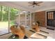 Inviting sunroom with brick wall, screened windows, ceiling fan and wicker chairs at 300 Hugh Crocker Rd, Matthews, NC 28104
