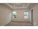 Spacious bedroom featuring plush carpet, tray ceilings, and natural light from two bright windows at 3156 Lilac Grove Dr, Charlotte, NC 28269