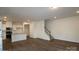 Open-concept living area with hardwood floors and staircase at 3156 Lilac Grove Dr, Charlotte, NC 28269