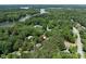 Aerial view of property surrounded by lush greenery and access to the lake at 3825 Mountain Cove Dr, Charlotte, NC 28216