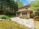 Backyard featuring a stone patio and landscaped garden beds creating an inviting outdoor living area at 3825 Mountain Cove Dr, Charlotte, NC 28216