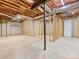 Unfinished basement featuring exposed beams and brick, presenting a blank canvas for the new homeowner at 3825 Mountain Cove Dr, Charlotte, NC 28216