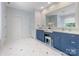 Bathroom with double sink vanity, granite countertops, and white tiled floors at 3825 Mountain Cove Dr, Charlotte, NC 28216