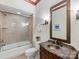 Bathroom features a tiled shower, marble countertop vanity and decorative lighting at 3825 Mountain Cove Dr, Charlotte, NC 28216