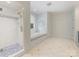 Bright bathroom featuring a glass shower, soaking tub and neutral tiling at 3825 Mountain Cove Dr, Charlotte, NC 28216