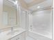 Bathroom with a single sink vanity and shower-tub combo with bright white finishes at 3825 Mountain Cove Dr, Charlotte, NC 28216