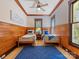 Charming bedroom featuring twin beds, wood paneling, and a blue patterned rug at 3825 Mountain Cove Dr, Charlotte, NC 28216