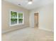 Bedroom featuring natural light and a doorway to a bathroom with a shower-tub combo at 3825 Mountain Cove Dr, Charlotte, NC 28216