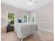 Bedroom featuring natural light from two windows and a decorative ceiling fan at 3825 Mountain Cove Dr, Charlotte, NC 28216