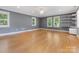 Bonus room featuring hardwood floors and multiple windows for ample natural light at 3825 Mountain Cove Dr, Charlotte, NC 28216