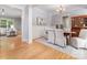 Elegant dining room with hardwood floors, wainscoting, and connection to living room at 3825 Mountain Cove Dr, Charlotte, NC 28216