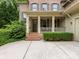 Inviting front porch with brick steps and decorative columns, enhancing the home's charming facade at 3825 Mountain Cove Dr, Charlotte, NC 28216
