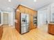 Kitchen boasts stainless steel refrigerator, wooden cabinets and an open layout at 3825 Mountain Cove Dr, Charlotte, NC 28216