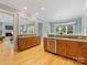 The open-concept kitchen features wooden cabinetry, granite countertops and stainless steel appliances at 3825 Mountain Cove Dr, Charlotte, NC 28216