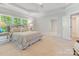 Spacious main bedroom featuring a plush bed, sitting area and views of the outdoors at 3825 Mountain Cove Dr, Charlotte, NC 28216