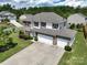 A drone shot of a two-story home with a three-car garage and well maintained lawns at 4321 Tucker Chase Dr, Midland, NC 28107
