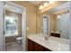 Bright bathroom with a large mirror, single vanity, and a window providing natural light at 4321 Tucker Chase Dr, Midland, NC 28107