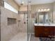 Modern bathroom with glass-enclosed shower, tile accents, and double vanity sinks at 4321 Tucker Chase Dr, Midland, NC 28107