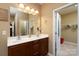 Bathroom featuring double sinks, bright lighting, and access to a closet at 4321 Tucker Chase Dr, Midland, NC 28107