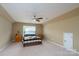 Bedroom featuring neutral walls, carpet, ceiling fan, window and matching wooden nightstands at 4321 Tucker Chase Dr, Midland, NC 28107