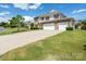 Beautiful two-story home showcasing a long driveway, three-car garage, and lush green lawn at 4321 Tucker Chase Dr, Midland, NC 28107