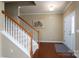 Inviting foyer features hardwood floors, a staircase with white banisters, and a white front door at 4321 Tucker Chase Dr, Midland, NC 28107