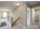 Upstairs hallway featuring carpet, wood railings and access to rooms including a full bathroom at 4321 Tucker Chase Dr, Midland, NC 28107
