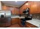 Modern kitchen featuring stainless steel appliances, granite countertops, and warm wood cabinets at 4321 Tucker Chase Dr, Midland, NC 28107