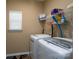 Bright laundry room with white washer, dryer, storage shelves and a window for natural light at 4321 Tucker Chase Dr, Midland, NC 28107