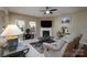 Comfortable living room with a fireplace, large windows, neutral paint, and plush seating at 4321 Tucker Chase Dr, Midland, NC 28107