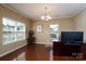 Bright office with hardwood floors, two windows, a chandelier, and a built-in desk at 4321 Tucker Chase Dr, Midland, NC 28107