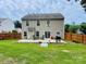 The backyard features a concrete patio with chairs and a barbeque, perfect for outdoor entertaining, enclosed by a wooden fence at 4698 Hannah Dr, Rock Hill, SC 29732