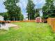 Large backyard features a storage shed, ride-on lawnmower, and a concrete patio next to the fence at 4698 Hannah Dr, Rock Hill, SC 29732