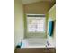 Large soaking tub in a bathroom with a window and tile floors at 4698 Hannah Dr, Rock Hill, SC 29732