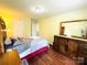 Bedroom with wood floors, ensuite bathroom, and modern rustic decor at 4698 Hannah Dr, Rock Hill, SC 29732