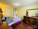 Bright bedroom with wood style floors, a large bed, and wood furnishings at 4698 Hannah Dr, Rock Hill, SC 29732