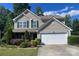 Charming two-story home featuring a well-manicured lawn, beautiful landscaping, and a two-car garage at 4698 Hannah Dr, Rock Hill, SC 29732