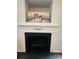 Close-up of a stylish fireplace with a decorative mantel and black hearth at 4698 Hannah Dr, Rock Hill, SC 29732